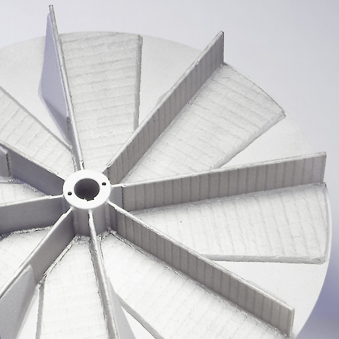 Wear-protected impeller for a material transport fan