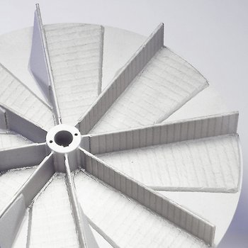 Wear-protected impeller for a material transport fan 
