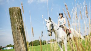 Employee Aline Pätzke riding a horse