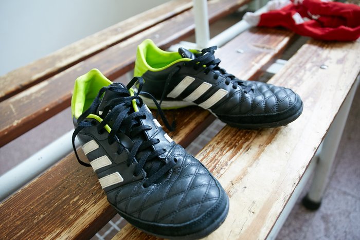 Football boots in a changing room